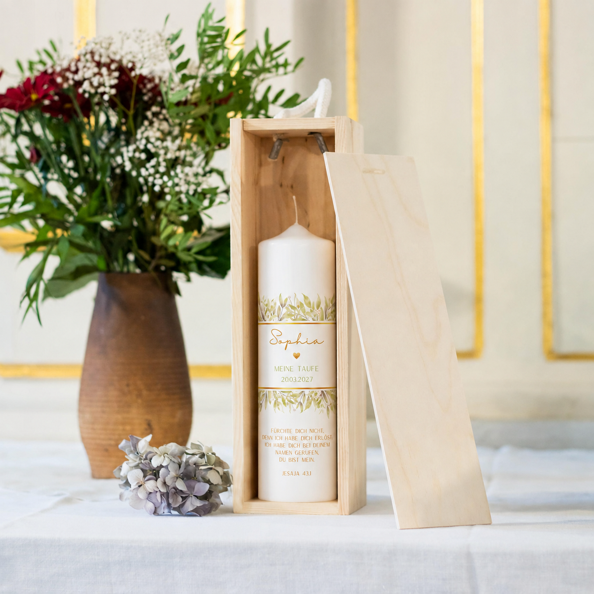 Taufkerze Greenery Olive Gold in der Holz-Kerzenbox neben Blumen als Geschenkidee