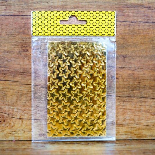 Wachsdekor Sterne gold glänzend auf Trägerpapier in der Verpackung